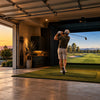 Golfer swinging into a home golf simulator enclosure in a two-car garage